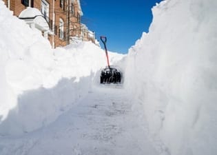 shovel on snowed-in sidewalk 