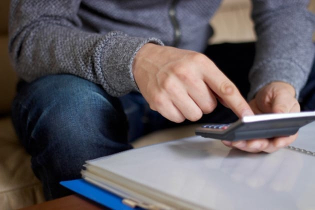 man using calculator 