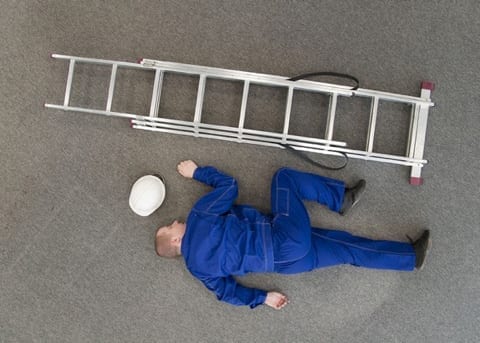 worker on the ground next to a ladder
