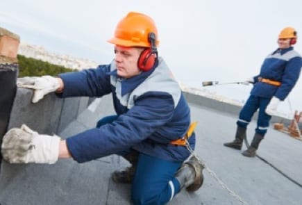 roofers installing flat roof membranes