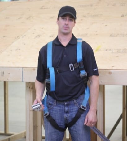 roofer wearing fall protection harness