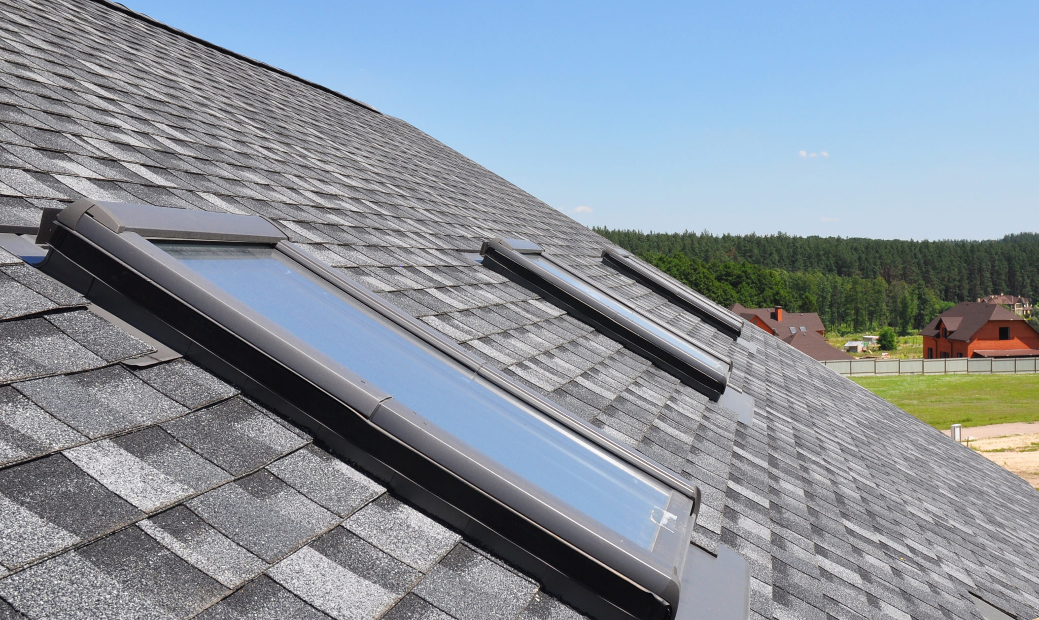 large shingled roof with 3 skylights