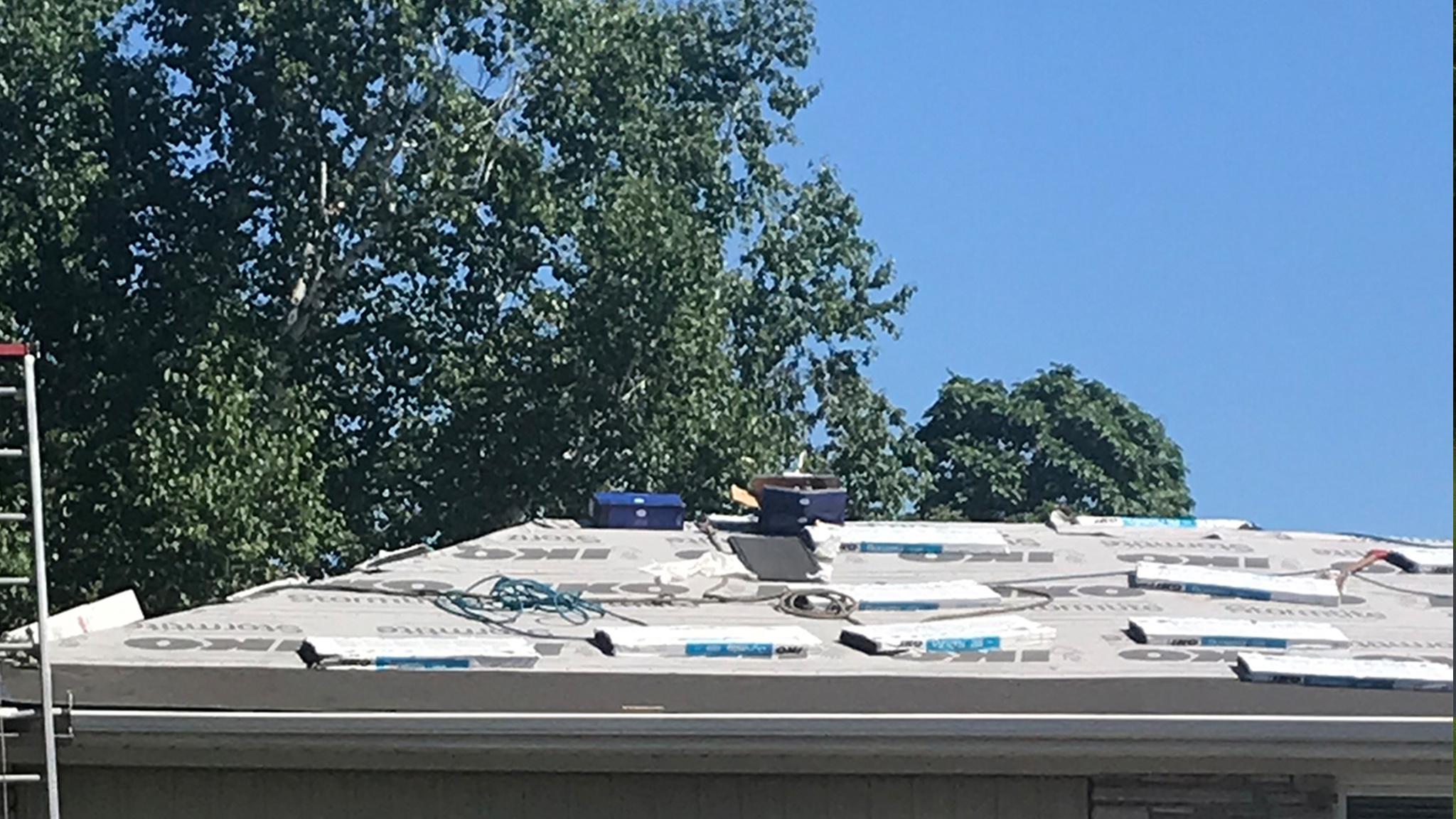 breaking shingle bundles into single bundles-on roof ridge