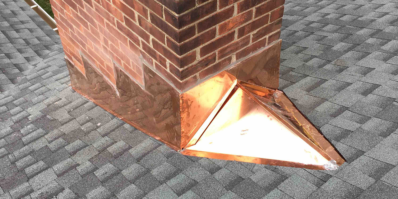 continuous copper flashing on a shingle roof chimney