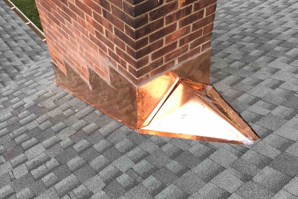 Continuous copper flashing on a shingle roof