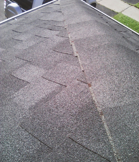 An example of poorly installed capping. Note how the roofer neglected to trim the unexposed part of the shingle."