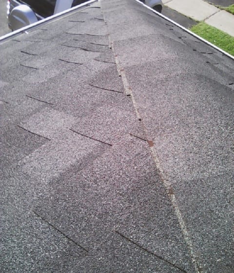 An example of poorly installed capping. Note how the roofer neglected to trim the unexposed part of the shingle.