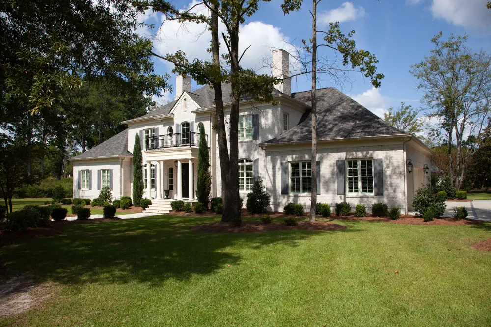 home surrounded by large tall trees