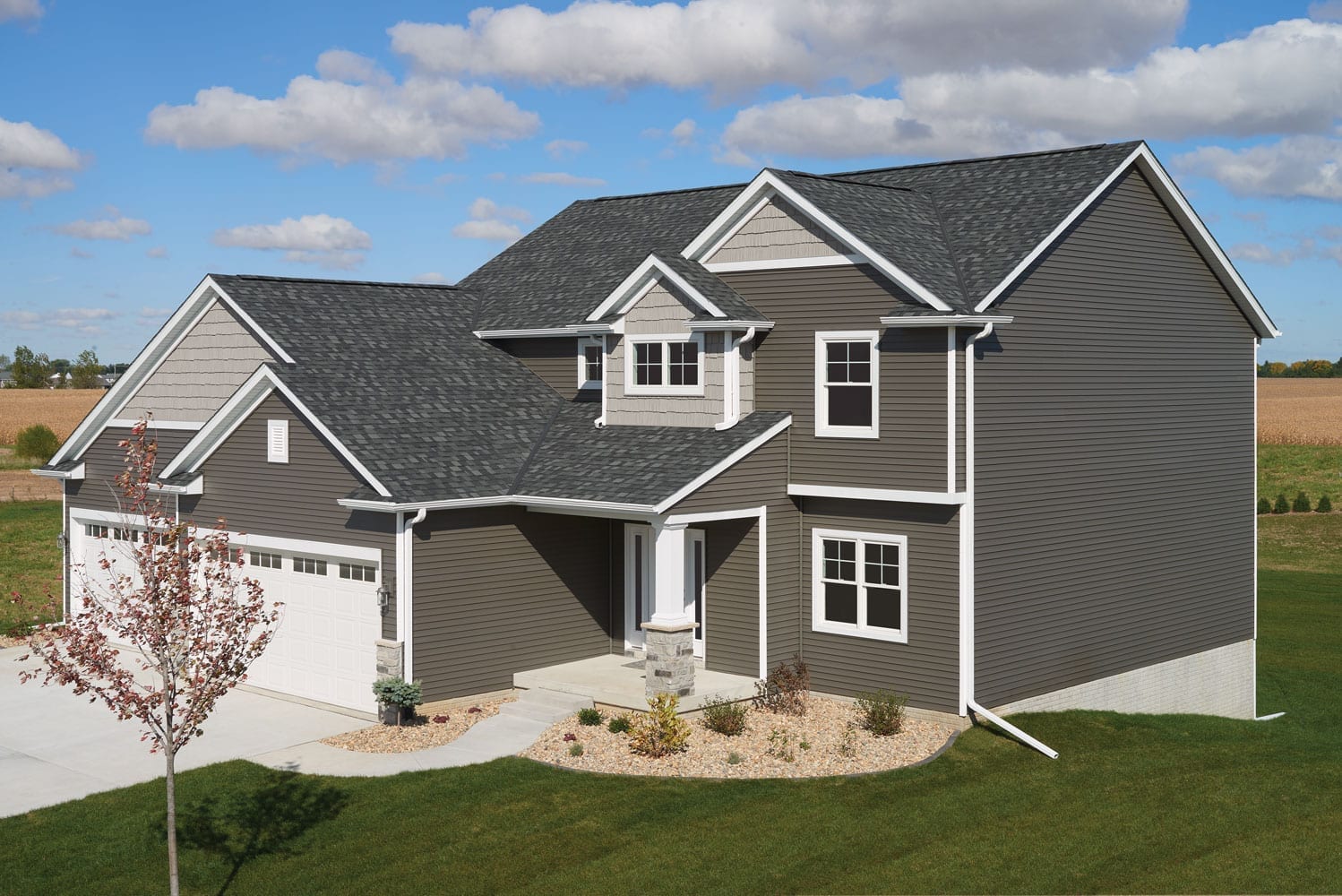 stormy grey siding with dark grey-black shingles on roof