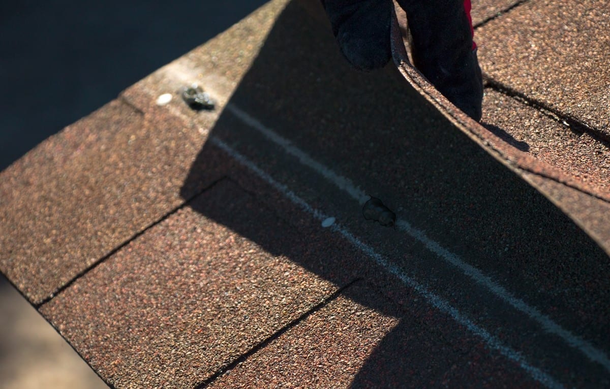 spots of asphalt plastic cement on a shingle