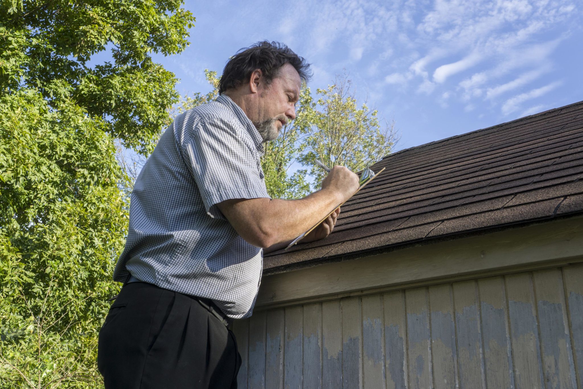 roof inspector inspecting a roof