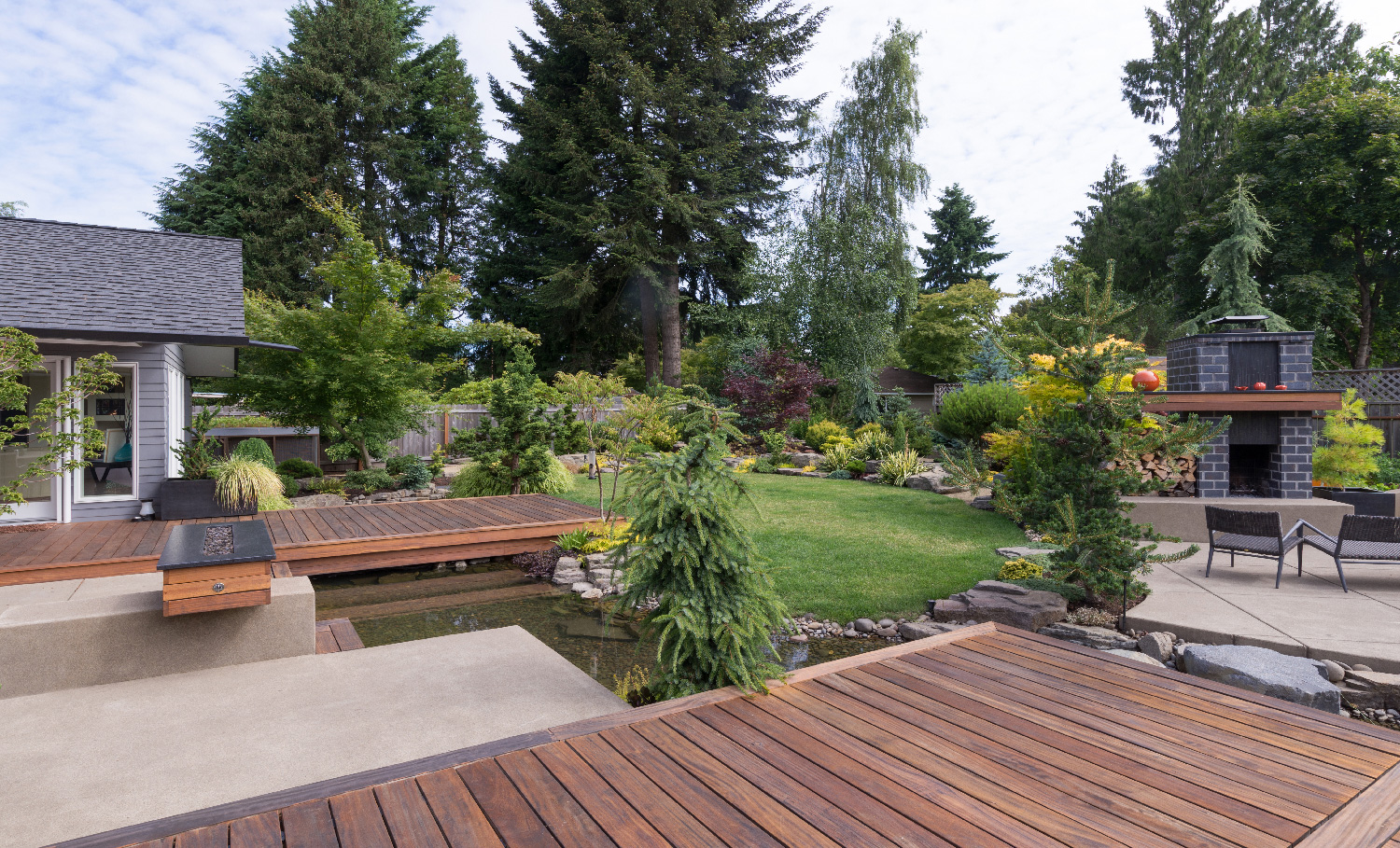 architectural shingle house with restful patio and deck area