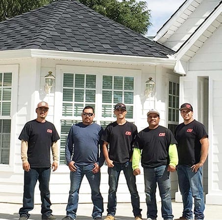 Chad’s Roofing, Inc., crew in front of the 9,500-square-foot roofing project.