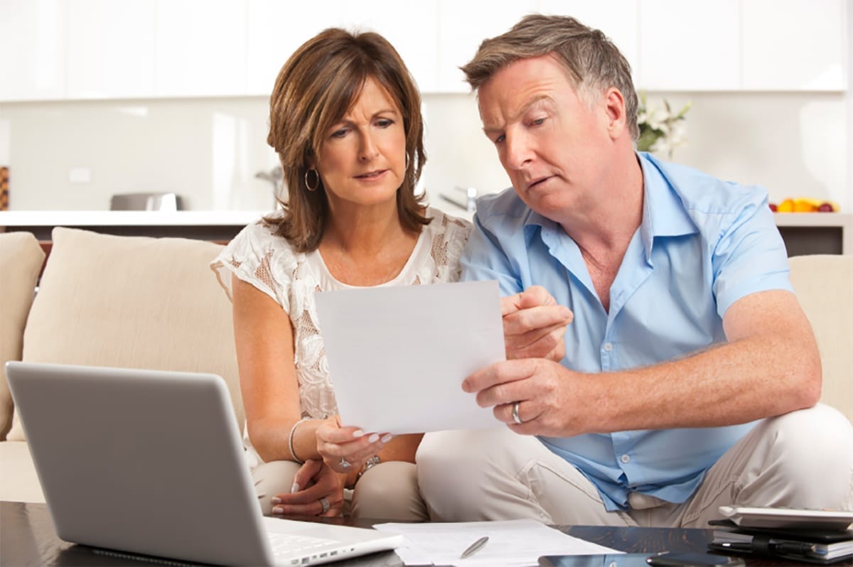 couple examining a document in their home