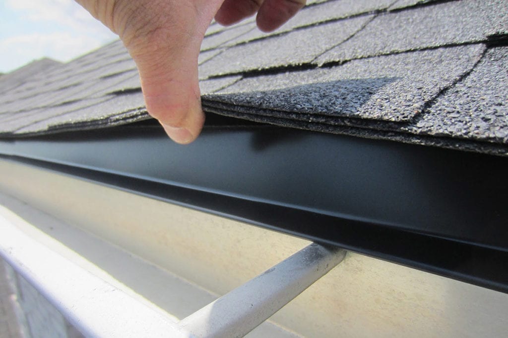 drip edge, gutter and lifted shingle