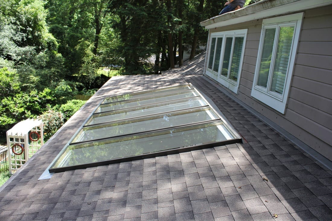 low sloped shingle roof with five skylights