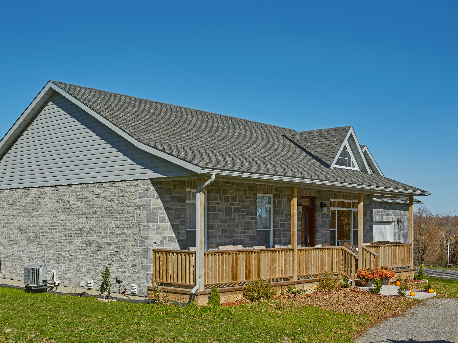 grey stone house with grey roofing shingles