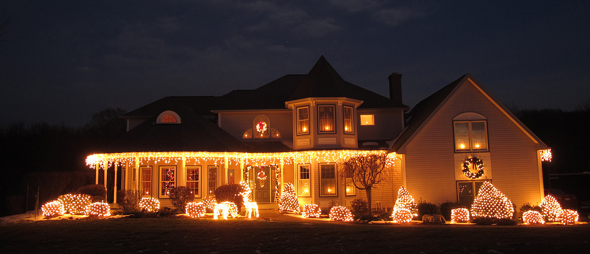 christmas lights hanging on first floor roof