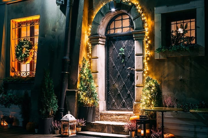 Xmas lights around entrance door arch and on window wreath