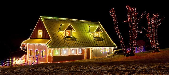 house outline lit up by Xmas lights
