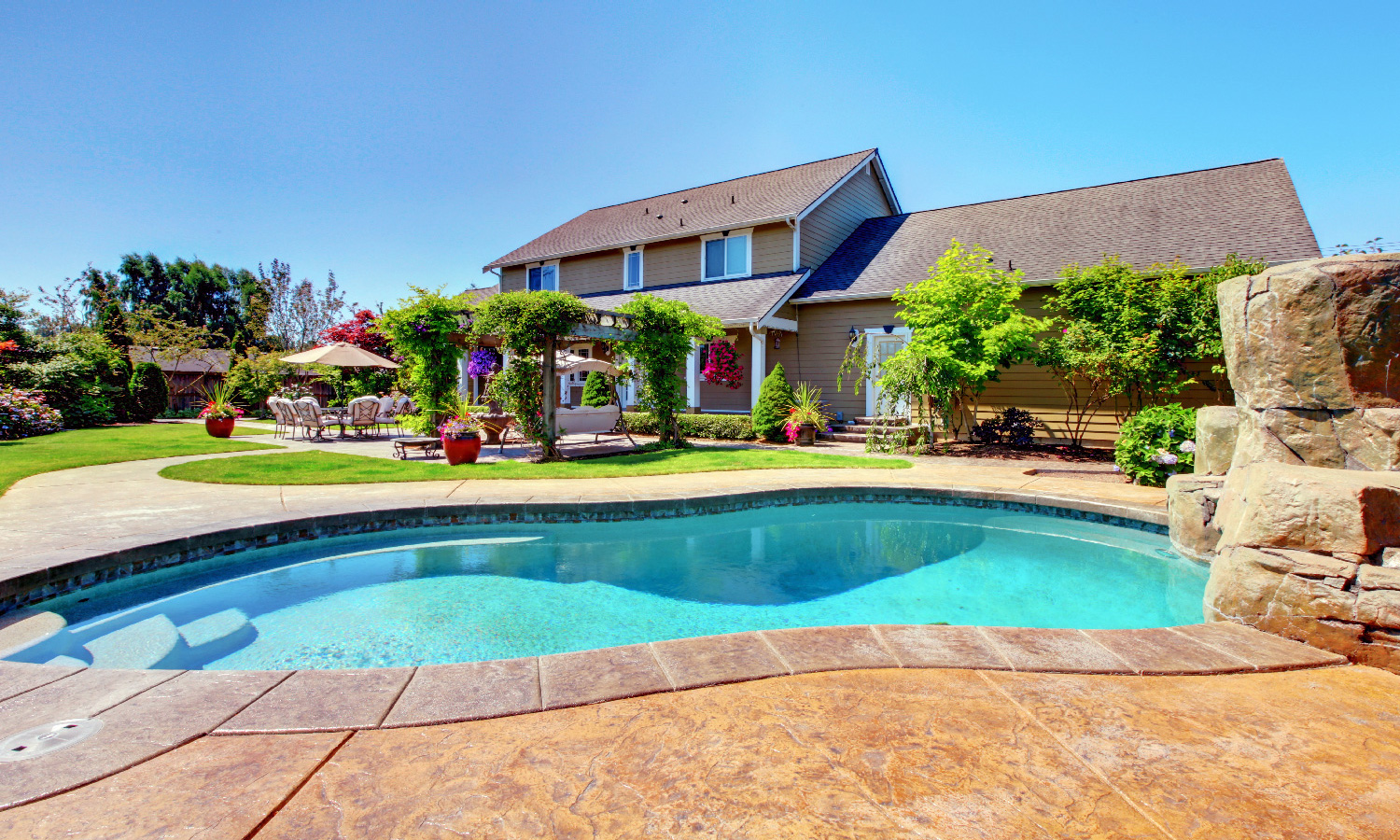 house with grey shingles and backyard pool