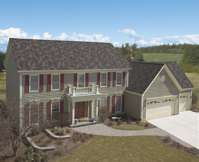 roof shingles with contrasting hues of light and dark grey to match the home's light grey siding