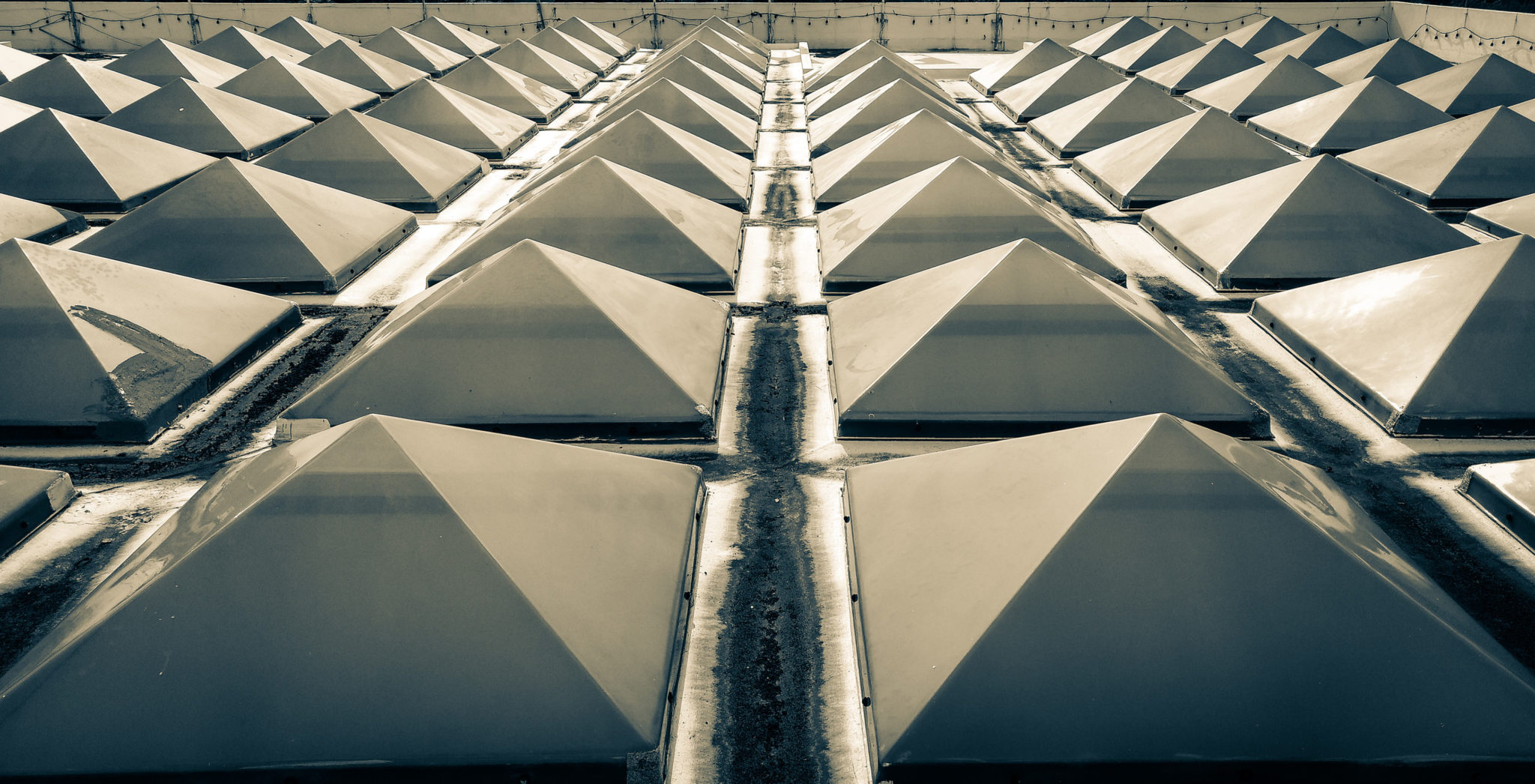 many pyramidal skylights on a flat roof