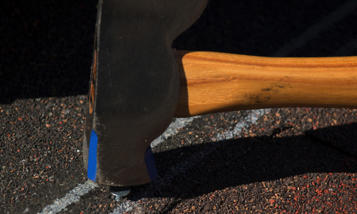 roofing Hammer driving nail into shingle