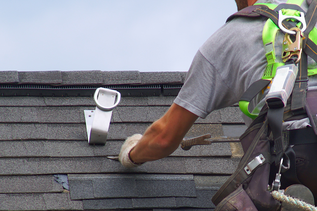 roof safety harness anchor attached to shingle roof