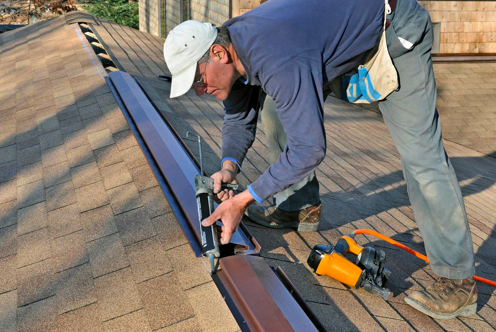 A roofer installing ridge vents