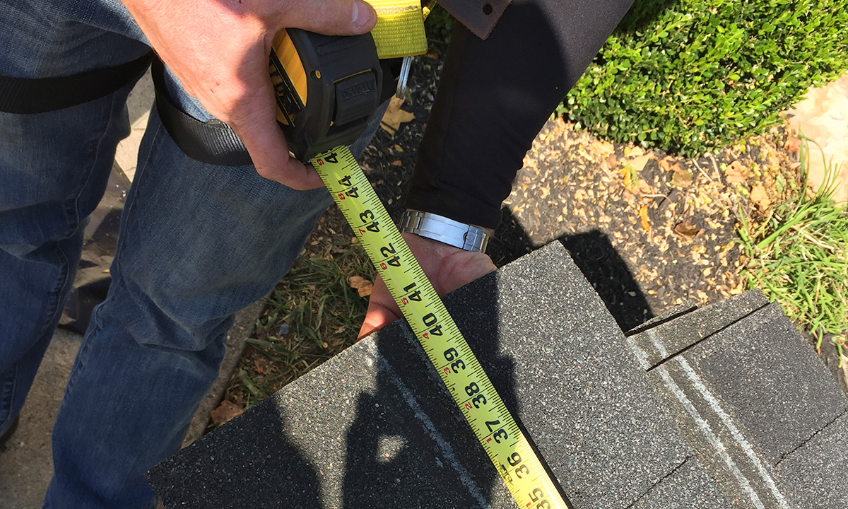 roofer using a Measuring Tape