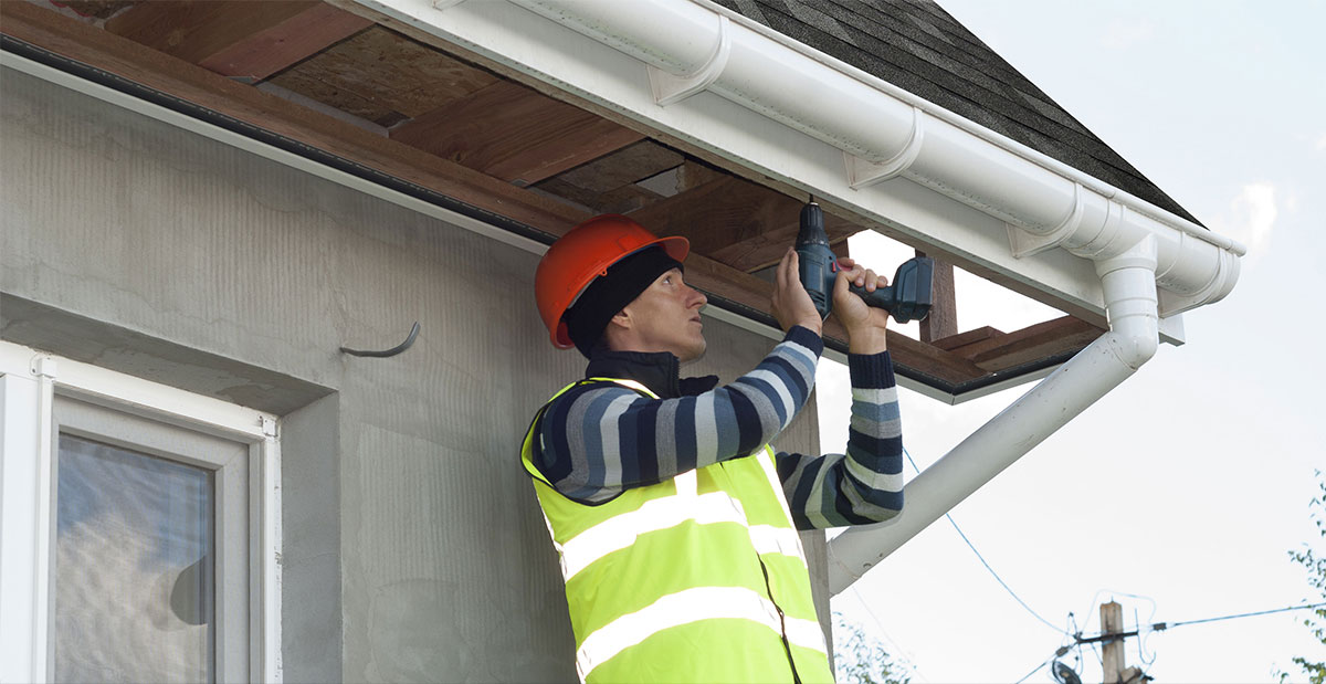 roofer installing fascia board