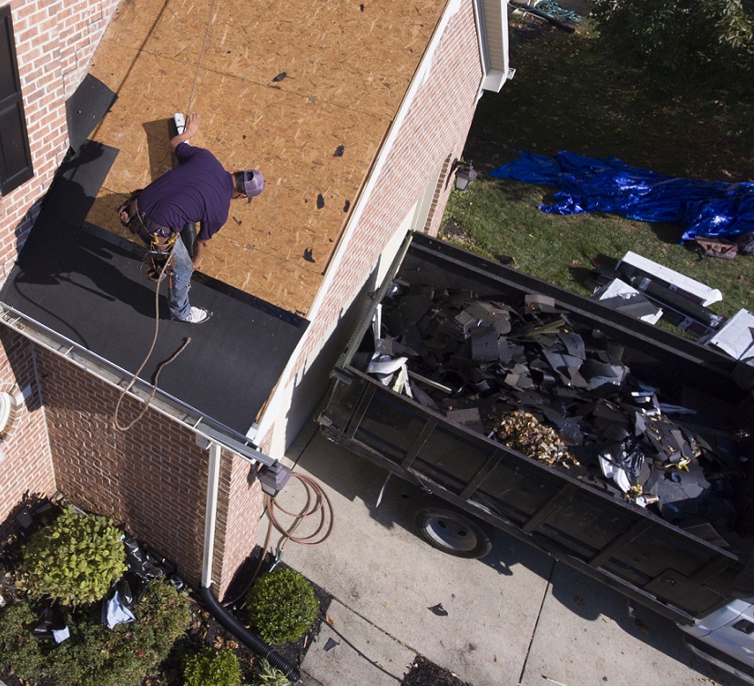 roofing shingles dumpster on driveway