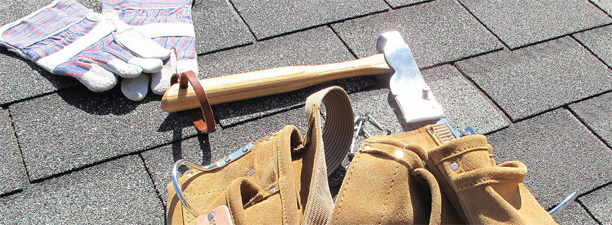 roofing tools on a shingle roof