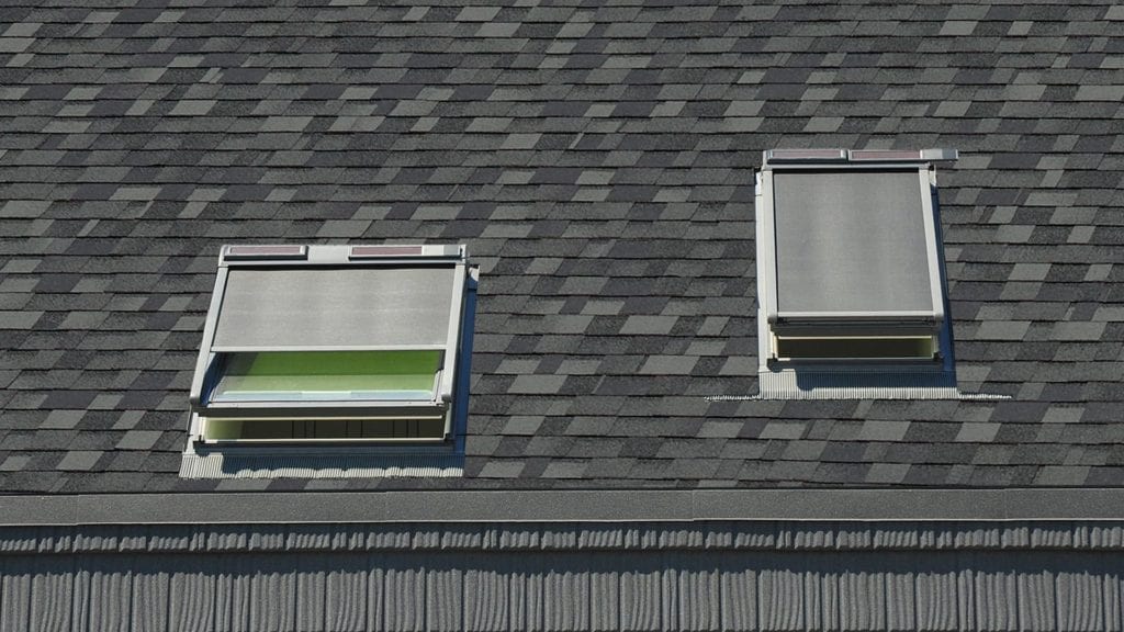 two skylights on a laminated shingle roof