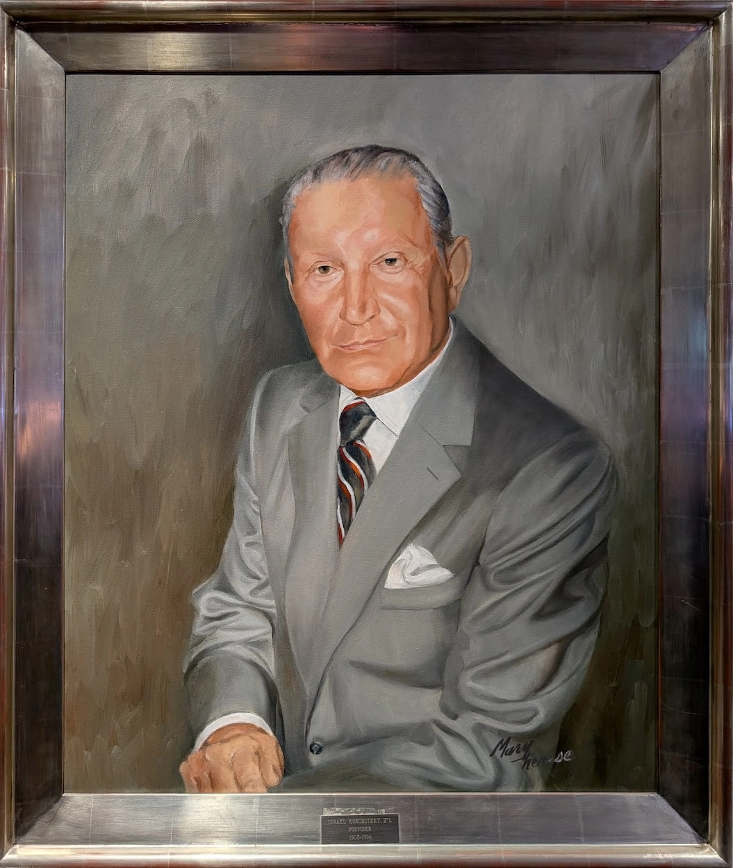 Framed oil portrait of Isadore in a gray suit and striped tie